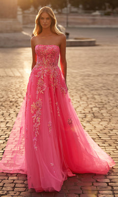 A woman stands outdoors at sunset in the La Femme Neon Pink Long Prom Ball Gown 32137, its strapless silhouette and floral embroidery glowing beautifully in the evening light.