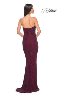 A woman, seen from behind, wears the La Femme Strapless Long Tube Prom Dress 32141—a floor-length burgundy gown with sparkling details. The background is white with the "La Femme" logo in the top right corner.