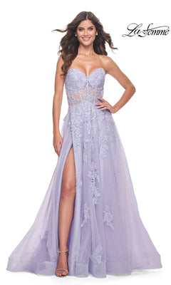 A woman poses with one hand on her hip in the La Femme Strapless Long Lace Prom Dress 32145, featuring lavender floral lace embroidery, a sheer bodice, and a high slit.