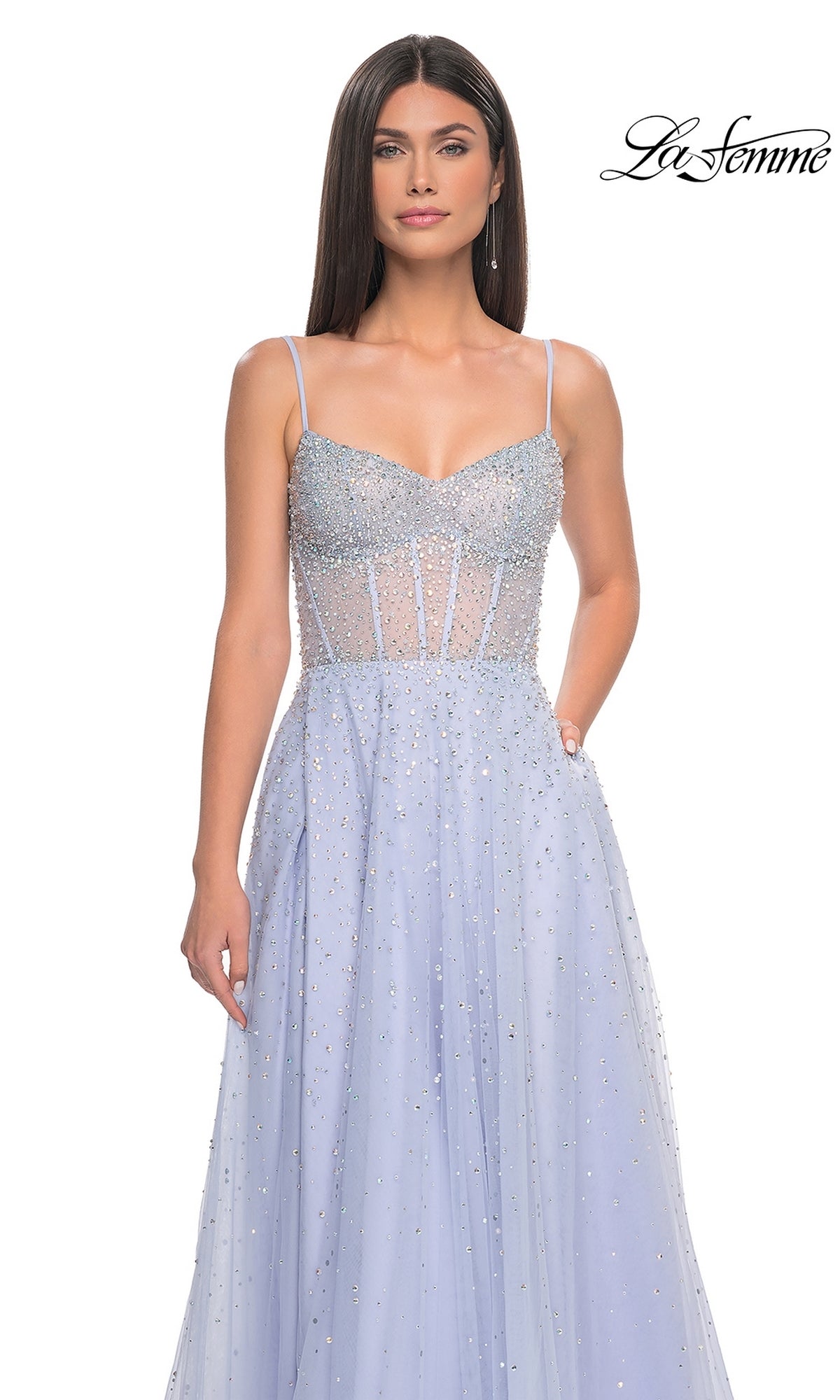 A woman wears the La Femme Beaded Long A-Line Prom Dress 32146, featuring light blue spaghetti straps, a semi-sheer bodice, beaded details, and a flowing skirt. The La Femme logo appears in the top right corner.