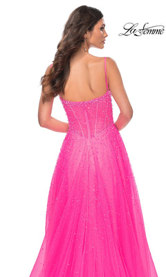 A woman is shown from behind wearing the La Femme Beaded Long A-Line Prom Dress 32146 in bright pink, featuring thin straps and a semi-sheer back, against a white background with the "La Femme" logo in the top right corner.