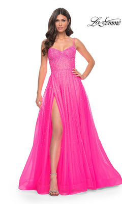 A woman poses with one hand on her hip in the La Femme Beaded Long A-Line Prom Dress 32146: a bright pink gown with spaghetti straps, beaded detail, and a thigh-high slit. The La Femme logo appears in the top right corner.