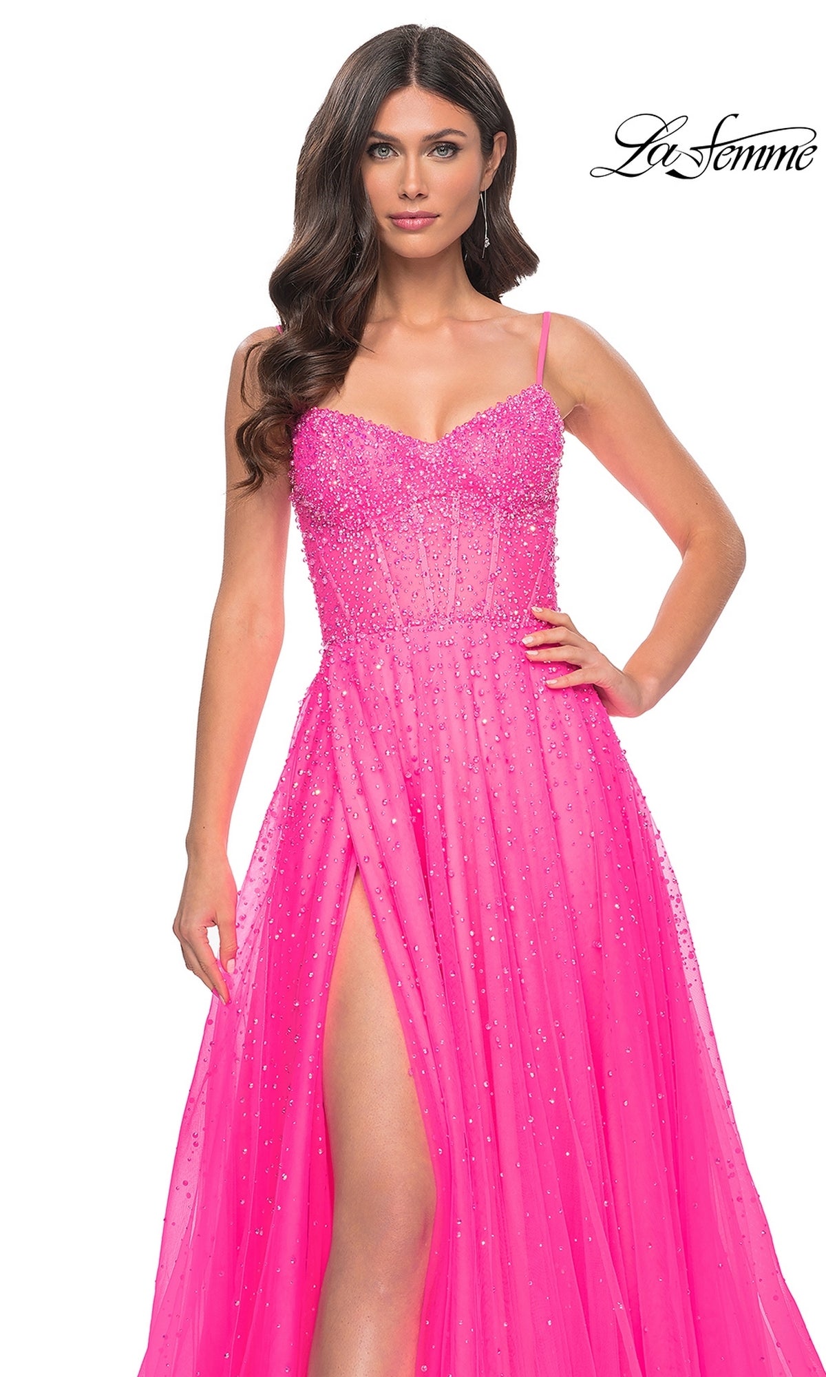 A woman wears the La Femme Beaded Long A-Line Prom Dress 32146 in bright pink, featuring beaded details, spaghetti straps, and a high slit. The La Femme logo appears in the top right corner.