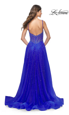 A woman faces away in the La Femme Beaded Long A-Line Prom Dress 32146, a floor-length royal blue gown with thin straps and sparkling beaded details. The La Femme logo is displayed in the upper right corner.
