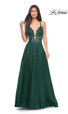 A woman wears the La Femme Lace-Embroidered Long Prom Dress 32147, featuring a deep green hue, thin straps, an embroidered floral lace bodice, and a full skirt. The La Femme logo is displayed in the upper right corner.