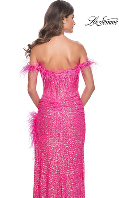A woman faces away wearing the La Femme Feather Long Pink Sequin Prom Dress 32150, featuring off-the-shoulder sleeves, feathered trim, a fitted silhouette, and sparkling sequins. The "La Femme" logo is in the top right corner.