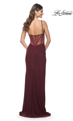 A woman with long brown hair, seen from behind, wears the La Femme Sheer-Back Tight Long Prom Dress 32160 in burgundy, featuring a sheer back and ruched detailing.