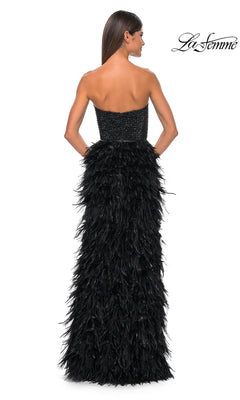 A woman is shown from the back wearing the La Femme Feather Strapless Long Prom Dress 32165, featuring an embellished sweetheart bodice and a dramatic feathered skirt. The La Femme logo appears in the top right corner.