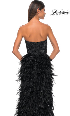 Woman wearing the La Femme Feather Strapless Long Prom Dress 32165, featuring an embellished sweetheart bodice and feathered skirt, shown from the back against a plain white background.
