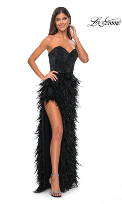 Woman wearing the La Femme Feather Strapless Long Prom Dress 32165, featuring an embellished sweetheart bodice, feathered skirt, and high slit, posing against a white background.