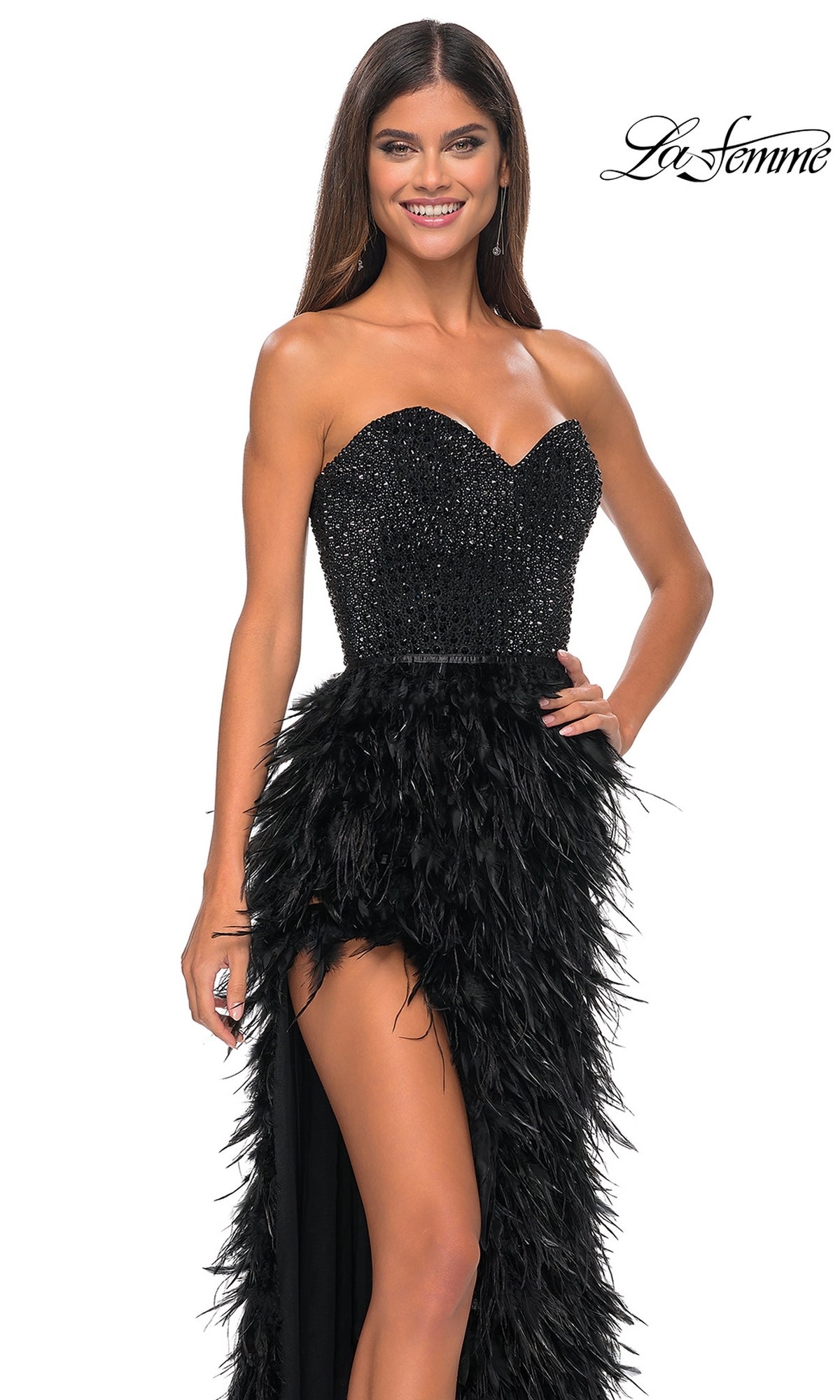 A woman smiles in the La Femme Feather Strapless Long Prom Dress 32165, featuring a sweetheart embellished bodice and feathered skirt, posing against a white background with the 