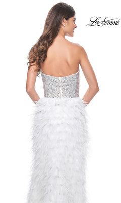 A woman faces away wearing the La Femme Feather Strapless Long Prom Dress 32165, featuring a sweetheart embellished bodice and a white feathered skirt; "La Femme" logo appears in the top right corner.