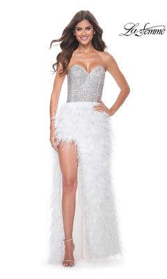 A woman wears the La Femme Feather Strapless Long Prom Dress 32165, featuring an embellished sweetheart bodice and a white feathered skirt with a high slit, posing against a plain white background.