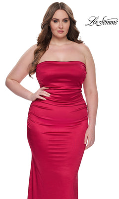 A woman models the La Femme Plus-Size Long Tube Prom Dress 32194, a strapless fitted red satin gown, posing against a white background with the "La Femme" logo in the top right corner.