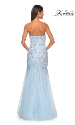 A woman models the La Femme Strapless Long Beaded Prom Dress 32197 in light blue, featuring a floor-length mermaid silhouette with sequin embellishments, elegantly shown from the back.