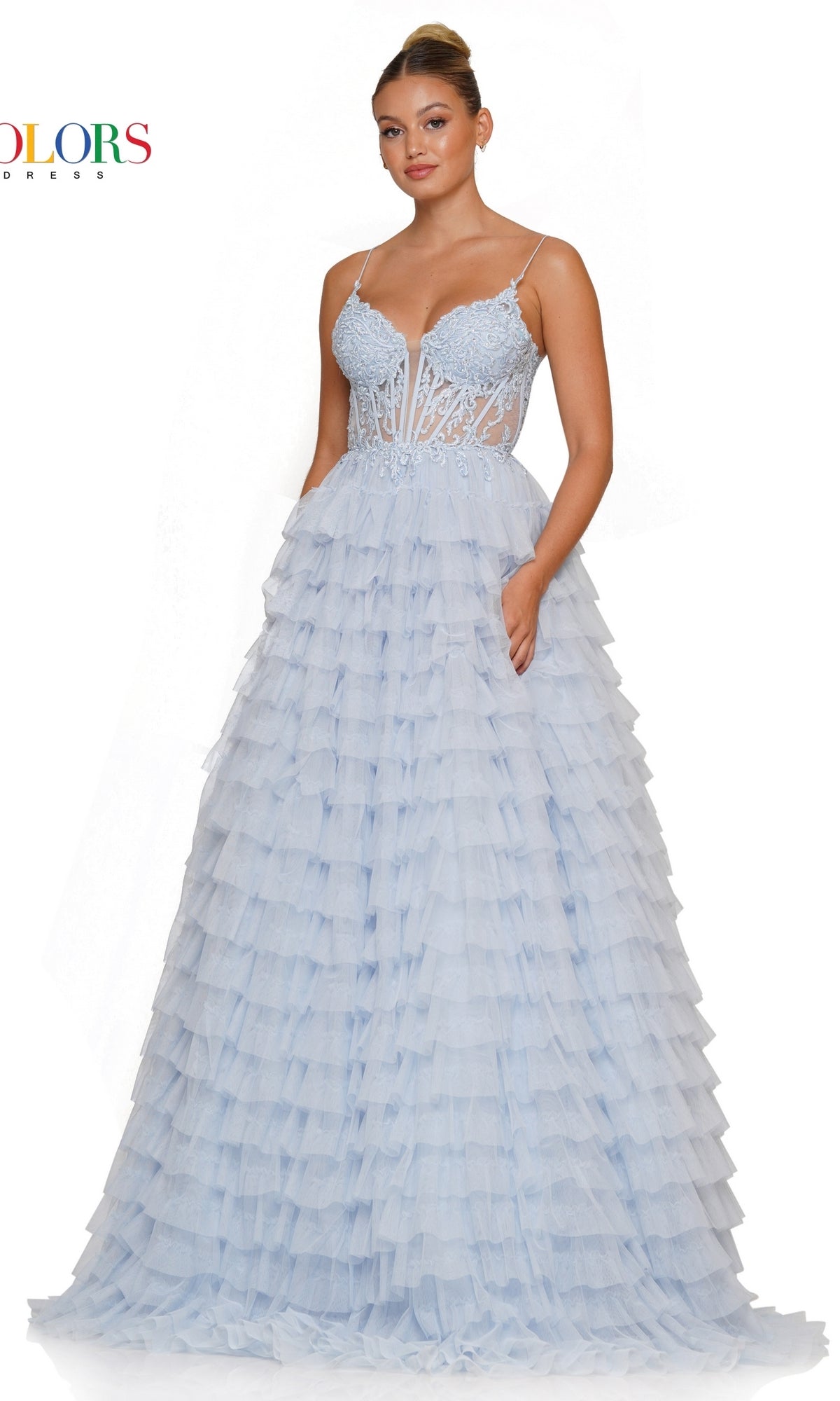 A woman wearing the Beaded-Corset Long Ruffled Prom Ball Gown 3219, a light blue, floor-length dress featuring a lace bodice, spaghetti straps, and a tiered ruffle skirt.