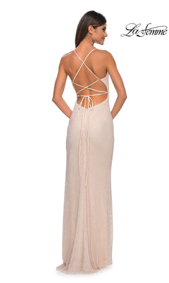 Woman in a light beige La Femme Embellished Long Fishnet Prom Dress 32203 with open back and crisscross lace-up straps, facing away from the camera.