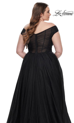 A woman faces away while wearing the La Femme Plus-Size Long A-Line Prom Dress 32204, featuring a black off-the-shoulder design with a sheer, striped bodice and full skirt. The “La Femme” logo appears in the top right corner.