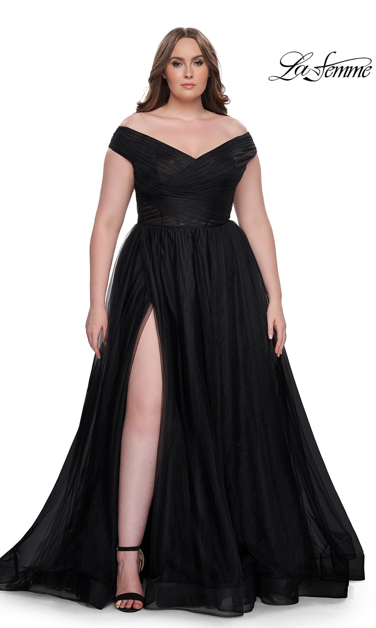 A woman wears the La Femme Plus-Size Long A-Line Prom Dress 32204, featuring an off-the-shoulder neckline and thigh-high slit, paired with black heels. She stands against a white background with the La Femme logo in the top right corner.