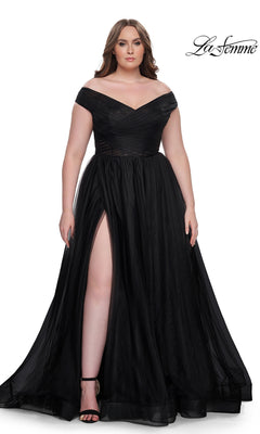 A woman wears the La Femme Plus-Size Long A-Line Prom Dress 32204, featuring an off-the-shoulder neckline and thigh-high slit, paired with black heels. She stands against a white background with the La Femme logo in the top right corner.