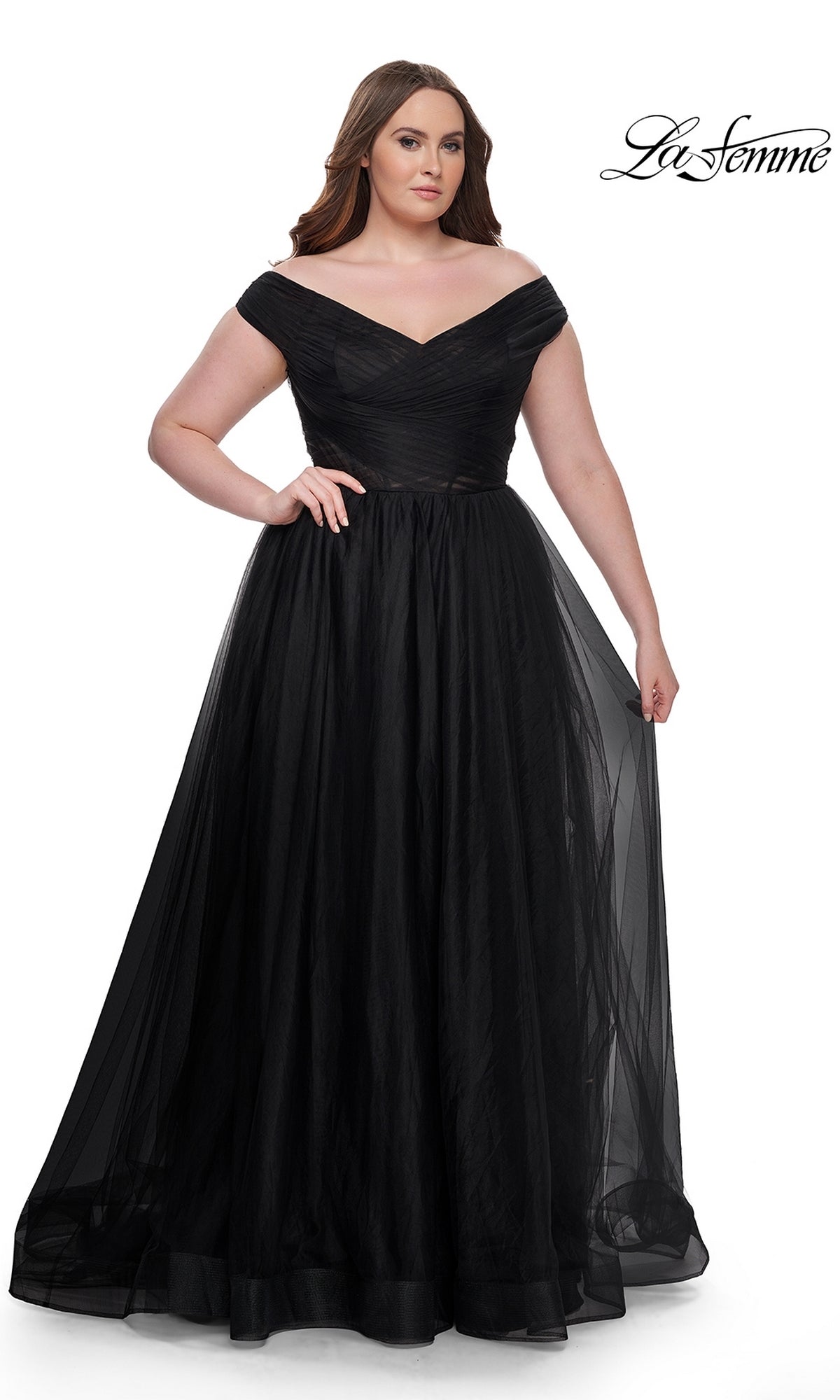 A woman wears the La Femme Plus-Size Long A-Line Prom Dress 32204, an off-the-shoulder gown with a fitted bodice and full tulle skirt, standing against a white background. The 
