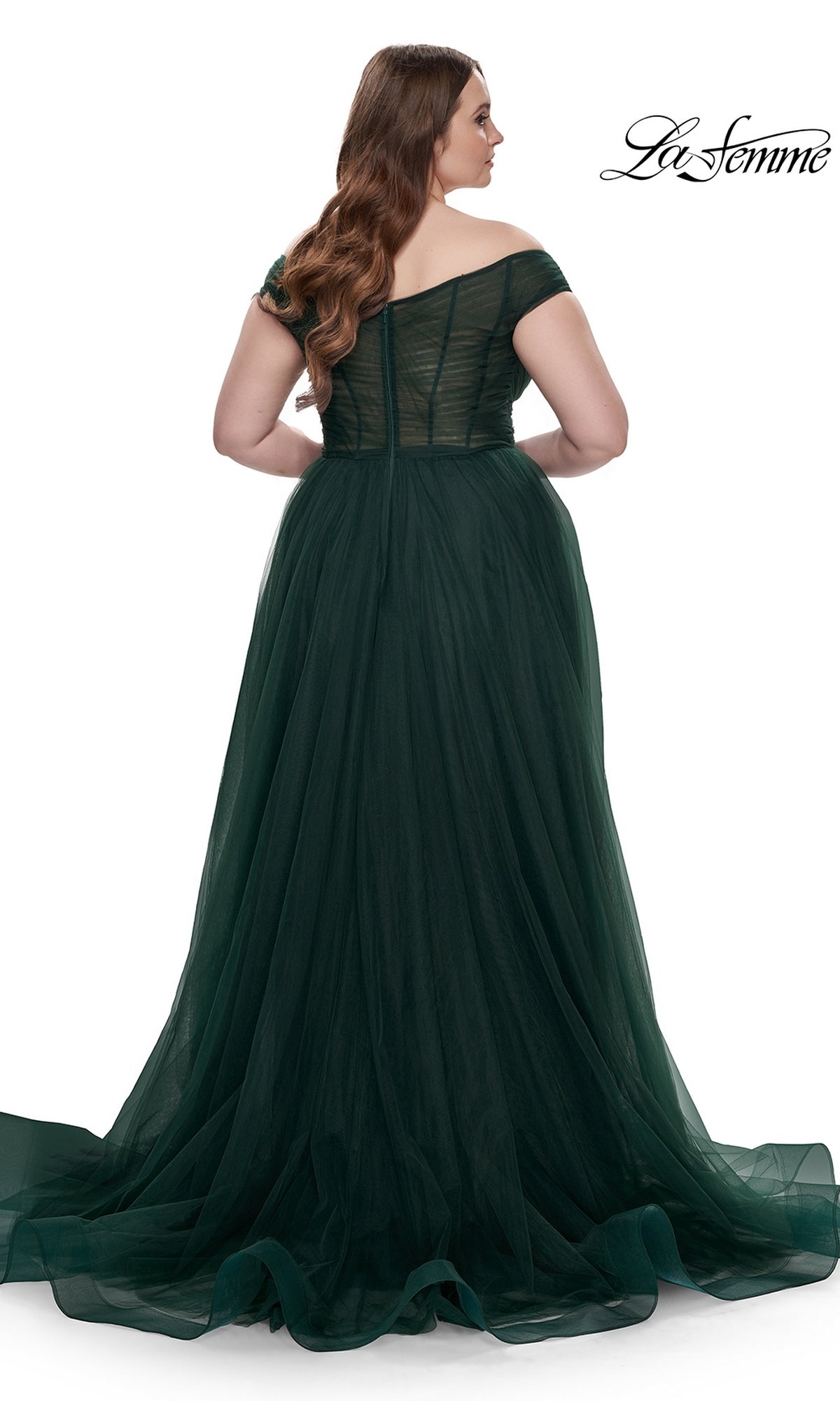 A woman is shown from the back in the La Femme Plus-Size Long A-Line Prom Dress 32204, a dark green off-the-shoulder designer gown with a fitted bodice and flowing tulle skirt, set against a white background for an elegant effect.