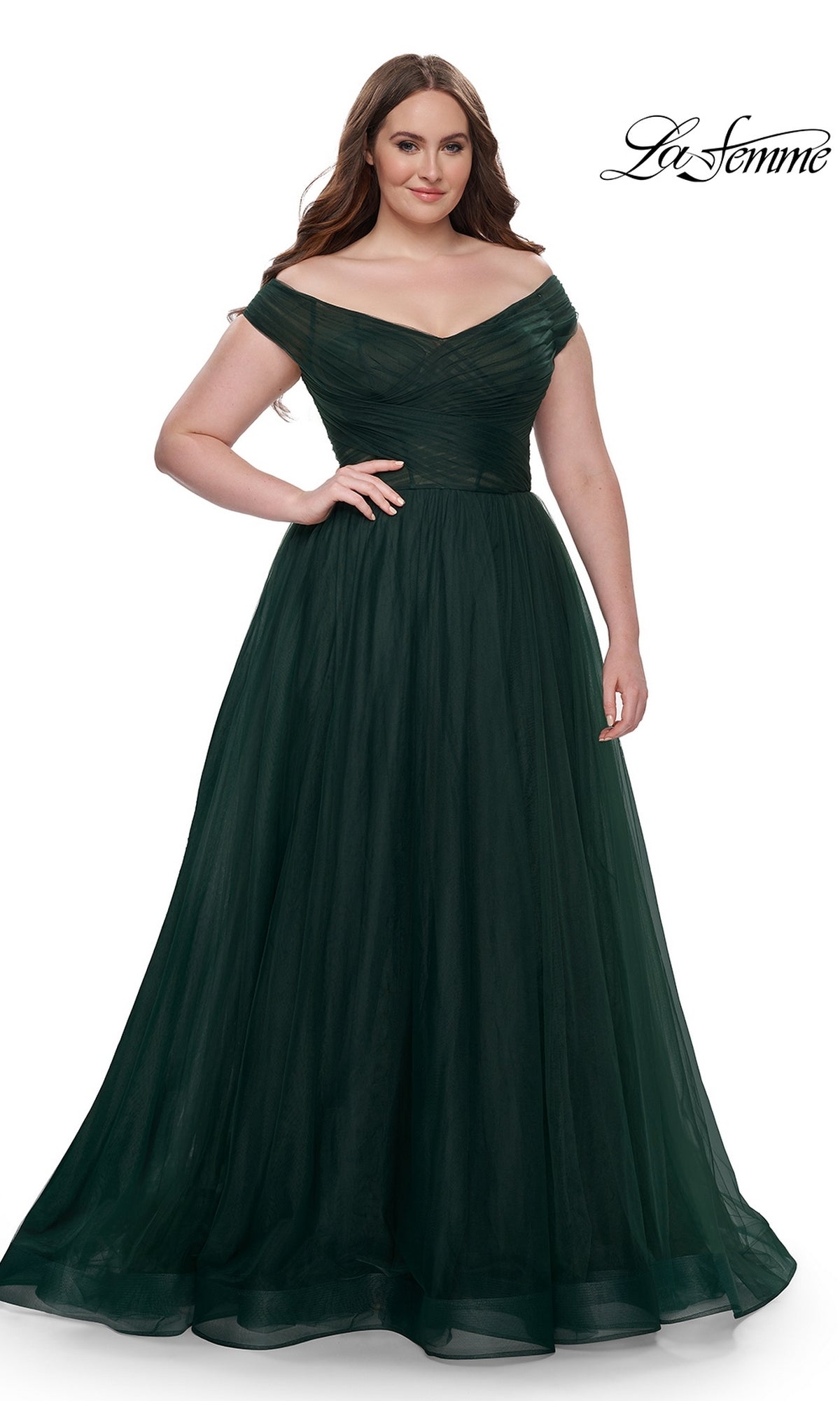 A woman wears the La Femme Plus-Size Long A-Line Prom Dress 32204 in dark green, standing against a white background with the 