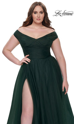 A woman models the La Femme Plus-Size Long A-Line Prom Dress 32204 in dark green, featuring an off-the-shoulder neckline, ruched bodice, and high slit, against a white background with the "La Femme" logo in the top right corner.