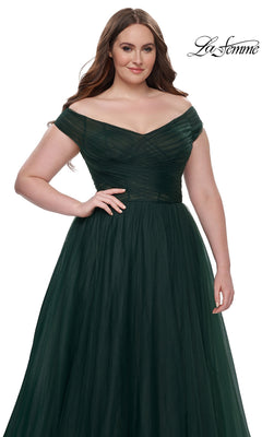 A woman poses against a white backdrop in the La Femme Plus-Size Long A-Line Prom Dress 32204, an off-the-shoulder, dark green, floor-length designer gown. The La Femme logo appears in the upper right corner.