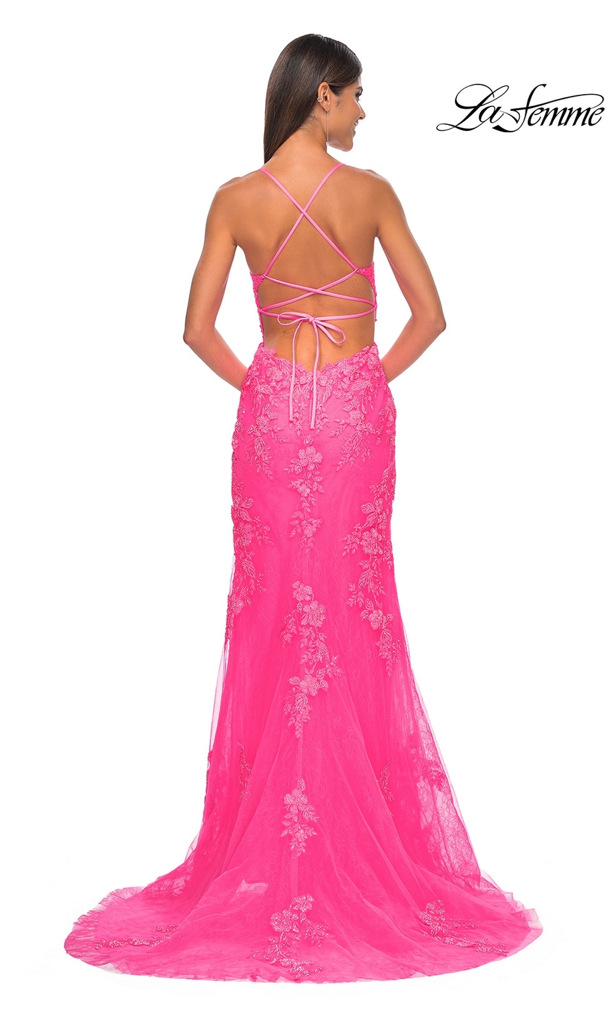 Woman in a bright pink La Femme Embroidered-Lace Long Prom Dress 32205 with floral lace and a crisscross open back, looking away. 