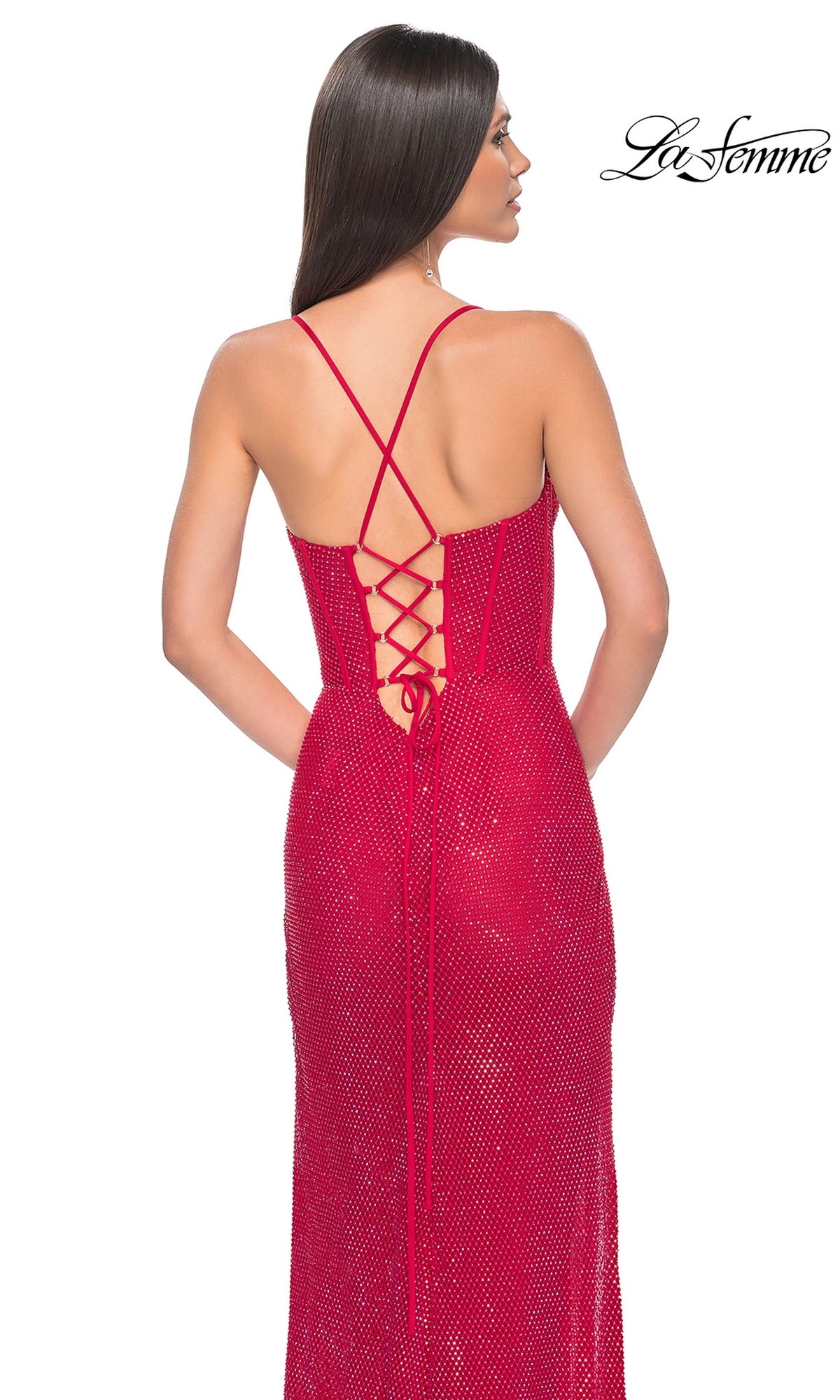 Woman in a red La Femme Long Bustier Fishnet Prom Dress 32210 with sparkly, strappy lace-up back, facing away; 