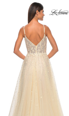 A woman poses with her back to the camera in the La Femme Embellished Long A-Line Prom Dress 32215, a sleeveless, sparkling light beige formal gown featuring a deep V-back. The La Femme logo is displayed in the top right corner.