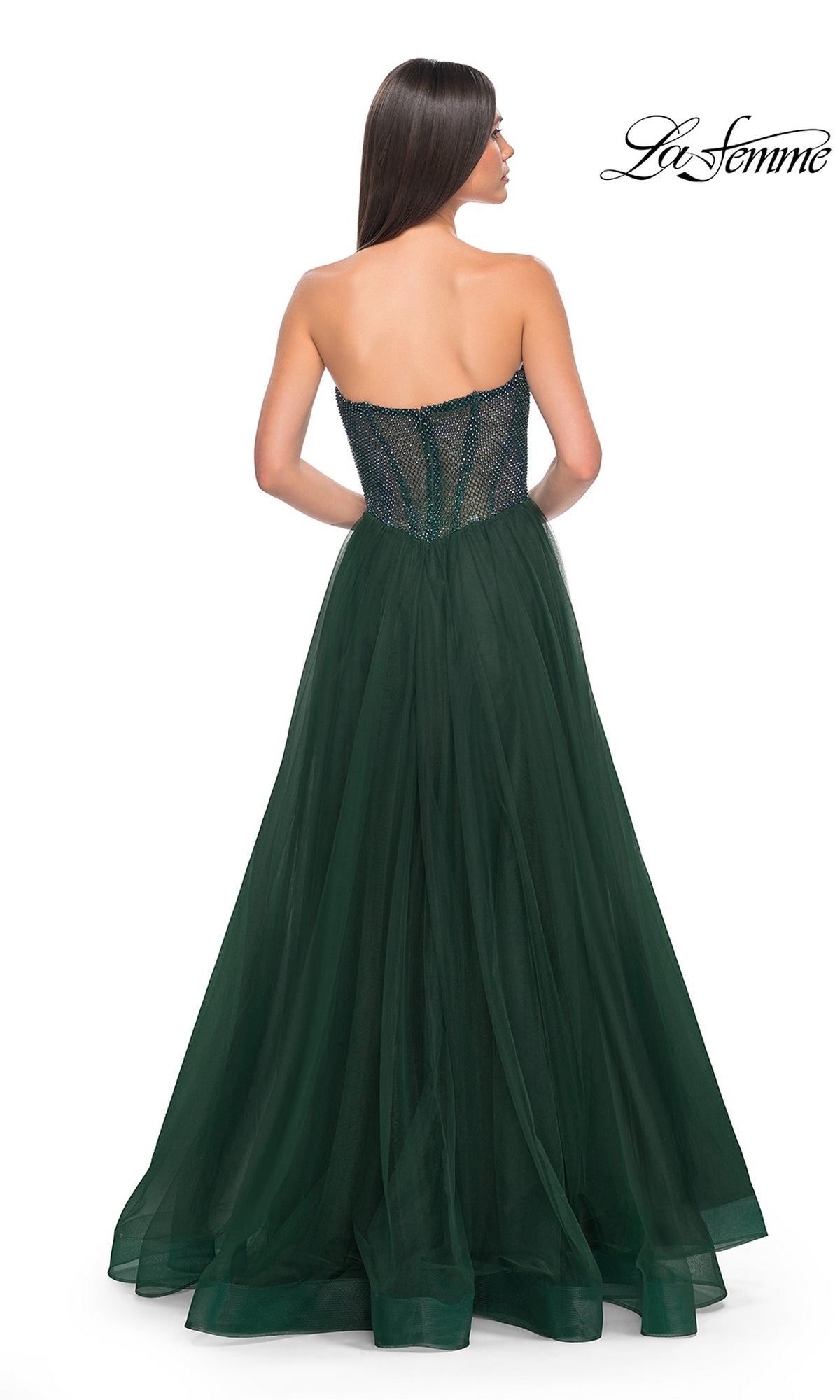 A woman faces away against a white background in the La Femme Strapless Long A-Line Prom Dress 32216, featuring a fitted embellished bodice and dark green tulle skirt.