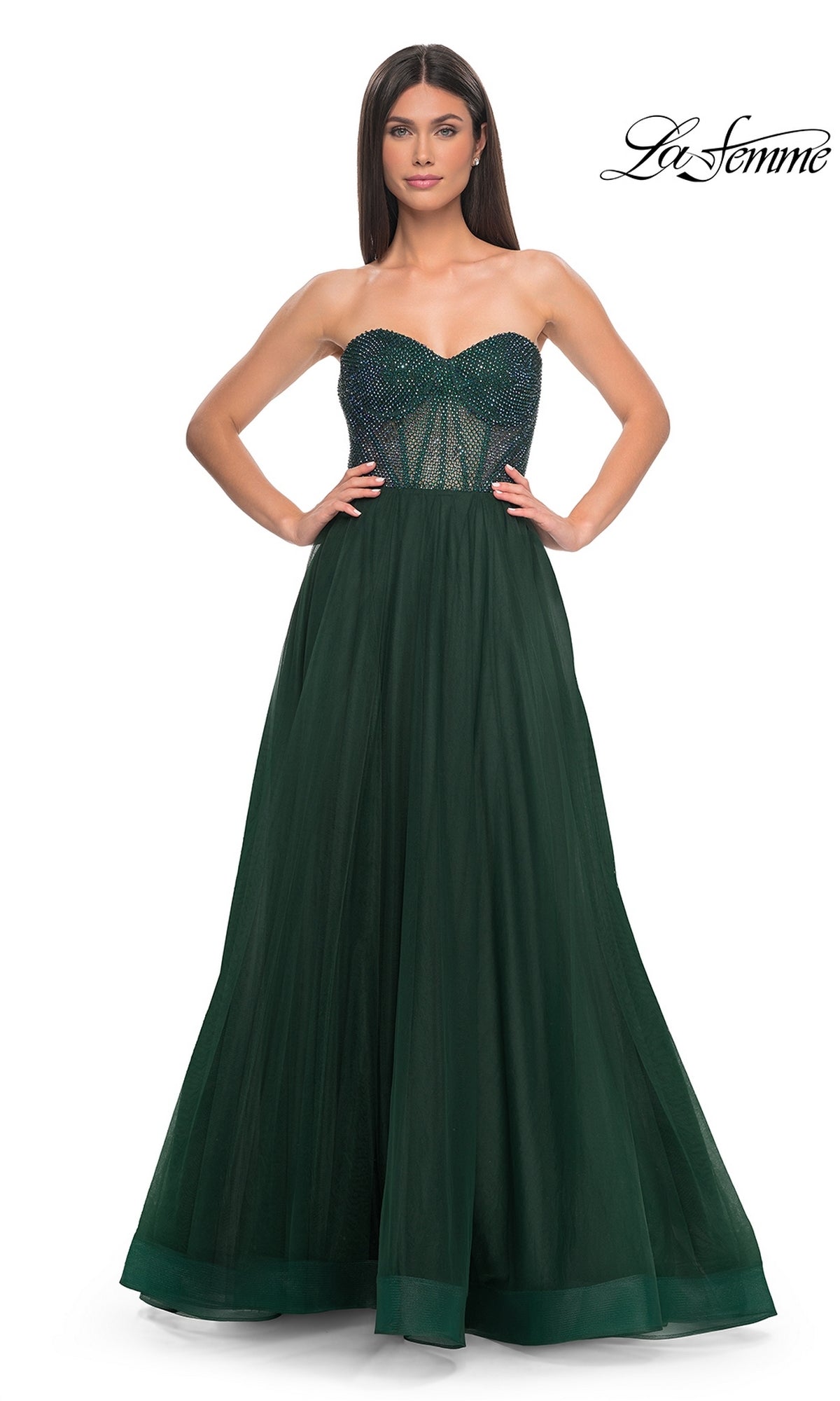 A woman models the La Femme Strapless Long A-Line Prom Dress 32216 in dark green, featuring a beaded semi-sheer bodice, against a white background. The 