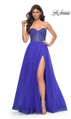 Woman wearing the La Femme Strapless Long A-Line Prom Dress 32216 in royal blue, featuring an embellished bodice and high thigh slit, standing on a white background.