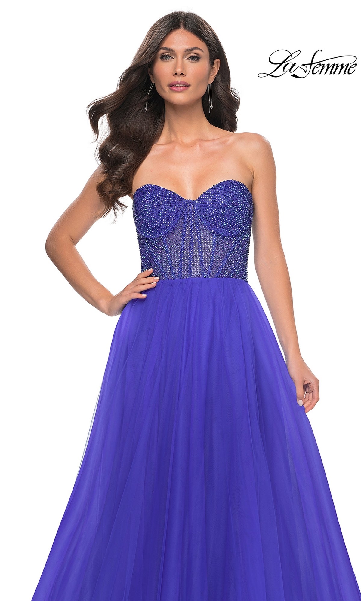 A woman wears the La Femme Strapless Long A-Line Prom Dress 32216 in royal blue, featuring a beaded sheer bodice and flowing tulle skirt; 