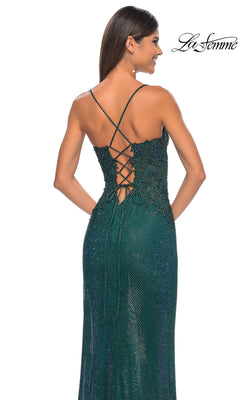 Woman in a dark green La Femme Rhinestone Fishnet Long Prom Dress 32218 with sparkly finish, thin straps, and an open back with lace-up detailing.