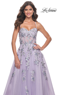 A woman poses with one hand on her hip in the La Femme Long Lavender A-Line Prom Dress 32221, featuring floral embroidery and thin straps.