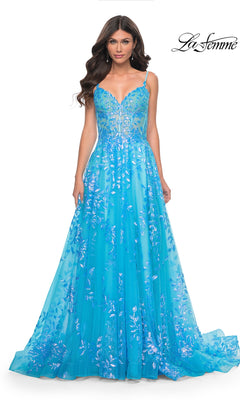 A woman wearing the La Femme Sequin-Print Long A-Line Prom Dress 32223 in bright blue with floral sequin details and thin straps, standing against a plain white background.