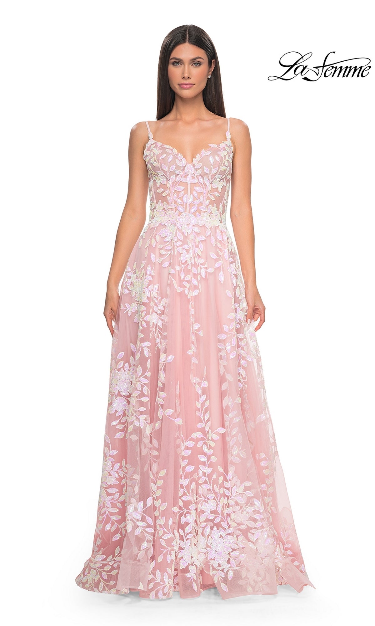 A woman in a pink La Femme Sequin-Print Long A-Line Prom Dress 32223 with thin straps stands facing forward against a white background. The La Femme logo is in the top right corner.