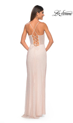 A woman stands with her back to the camera, wearing the La Femme Sheer Bustier Long Prom Dress 32227 in light pink, featuring a crisscross lace-up open back.