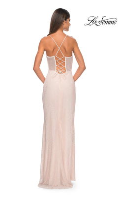 A woman stands with her back to the camera in a floor-length, light pink La Femme Sheer Bustier Long Prom Dress 32227 featuring a lace-up, strappy back. The La Femme logo is visible in the top right corner.