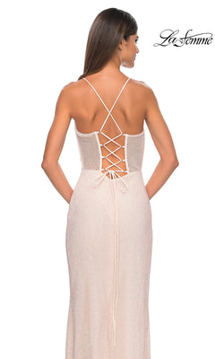 A woman stands facing away, showcasing the fitted La Femme Sheer Bustier Long Prom Dress 32227 with a crisscross lace-up back. The "La Femme" logo appears in the upper right corner.