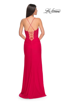 A woman seen from behind wears the La Femme Lace-Up Long Fishnet Prom Dress 32230, featuring a sheer corset bodice, lace-up back, and thin crisscross straps. The La Femme logo appears in the upper right corner.