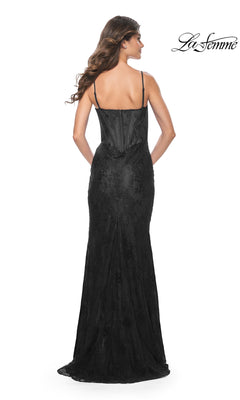 Woman wearing the La Femme Corset-Bodice Long Lace Prom Dress 32231 featuring a fitted black floral lace design and thin straps, shown from the back against a white background with "La Femme" logo in the top right corner.