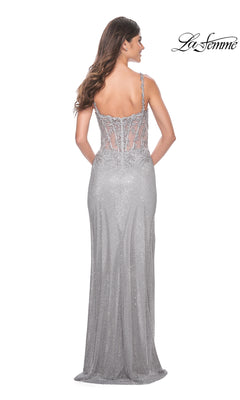 A woman models the La Femme Lace-Bodice Long Prom Dress 32232, featuring silver beading, embroidery, thin straps, and a sheer lace-up back. She faces away from the camera. "La Femme" logo appears in the top right corner.