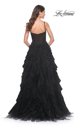 Woman wearing the La Femme Sheer-Waist Long Ruffled Prom Dress 32233, a stunning strapless evening gown with a fitted bodice and layered tulle skirt, featuring elegant ruffles—photographed from the back.