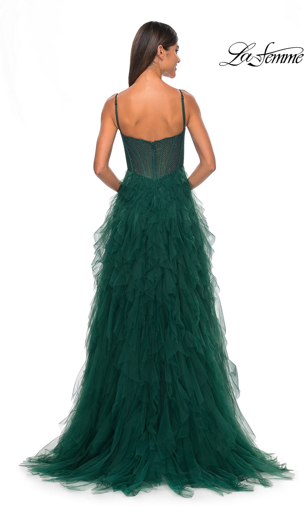 A woman faces away, wearing a dark green, floor-length La Femme Sheer-Waist Long Ruffled Prom Dress 32233 with thin straps and a fitted bodice; 