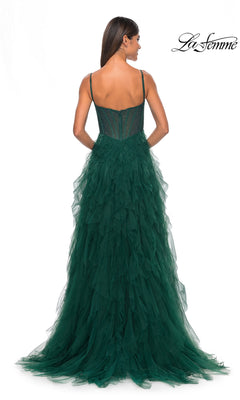 A woman faces away, wearing a dark green, floor-length La Femme Sheer-Waist Long Ruffled Prom Dress 32233 with thin straps and a fitted bodice; "La Femme" logo appears in the top right corner.