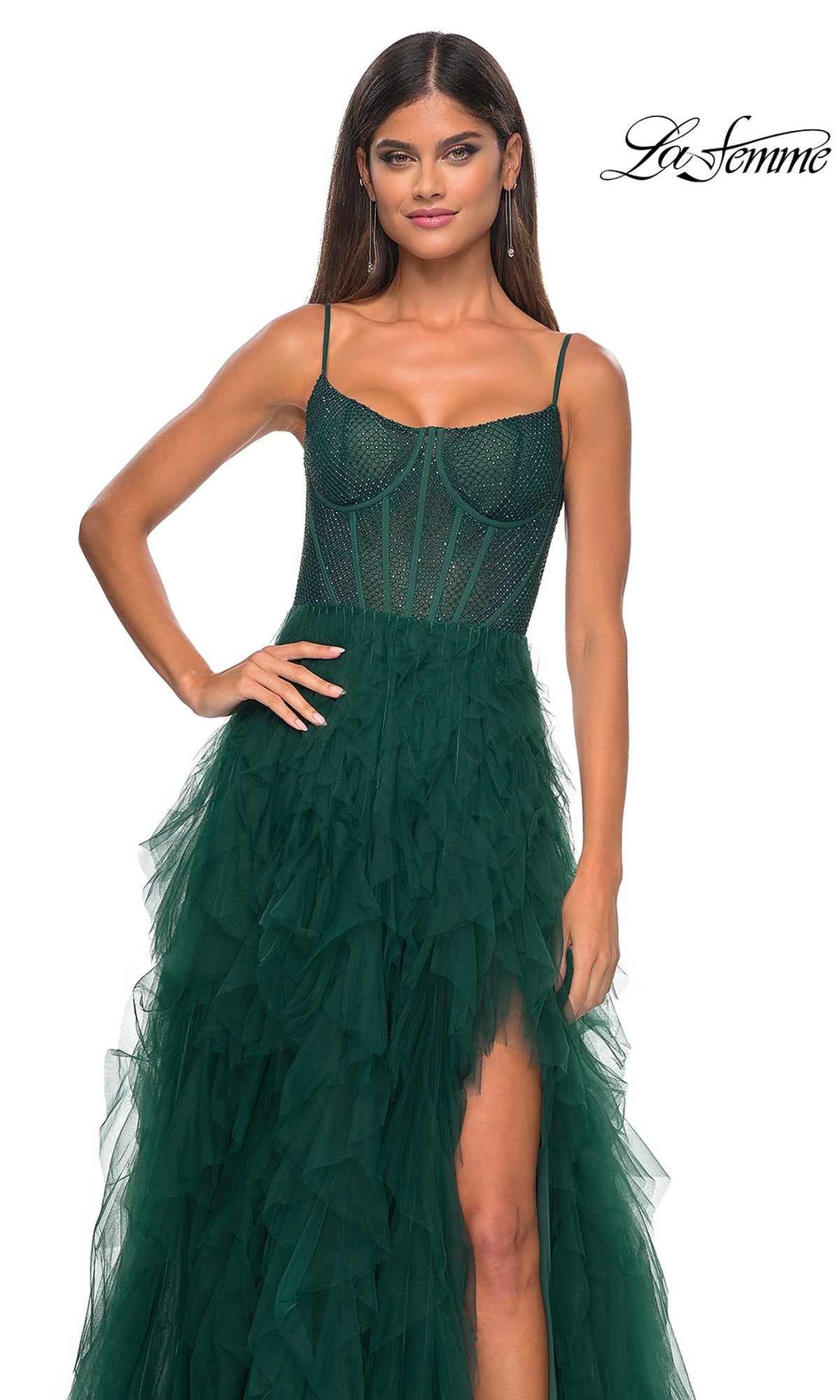 A woman in a dark green La Femme Sheer-Waist Long Ruffled Prom Dress 32233, featuring a sleeveless beaded bodice and layered tulle skirt with a high slit; La Femme logo appears in the top right corner.